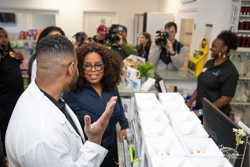 Pharmacist Martez Prince showing Oprah Winfrey around.